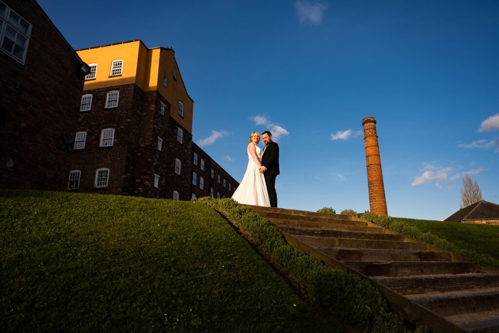 Bride and groom by industrial wedding venue